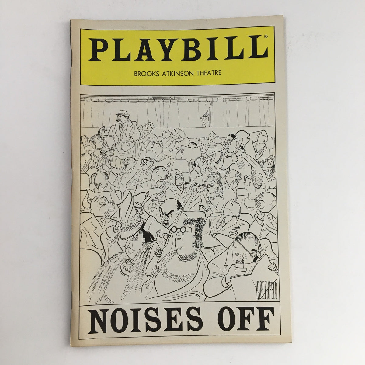 1984 Playbill for Noises Off at Brooks Atkinson Theatre featuring a humorous illustration of the audience and performers.