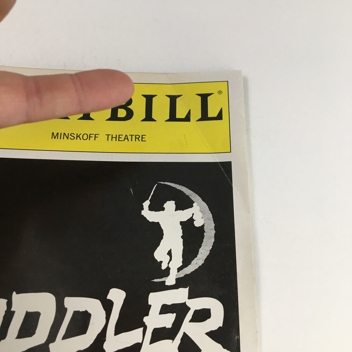 Close-up of the top corner of the 2004 Playbill for Fiddler on the Roof from Minskoff Theatre showing minor wear and details.