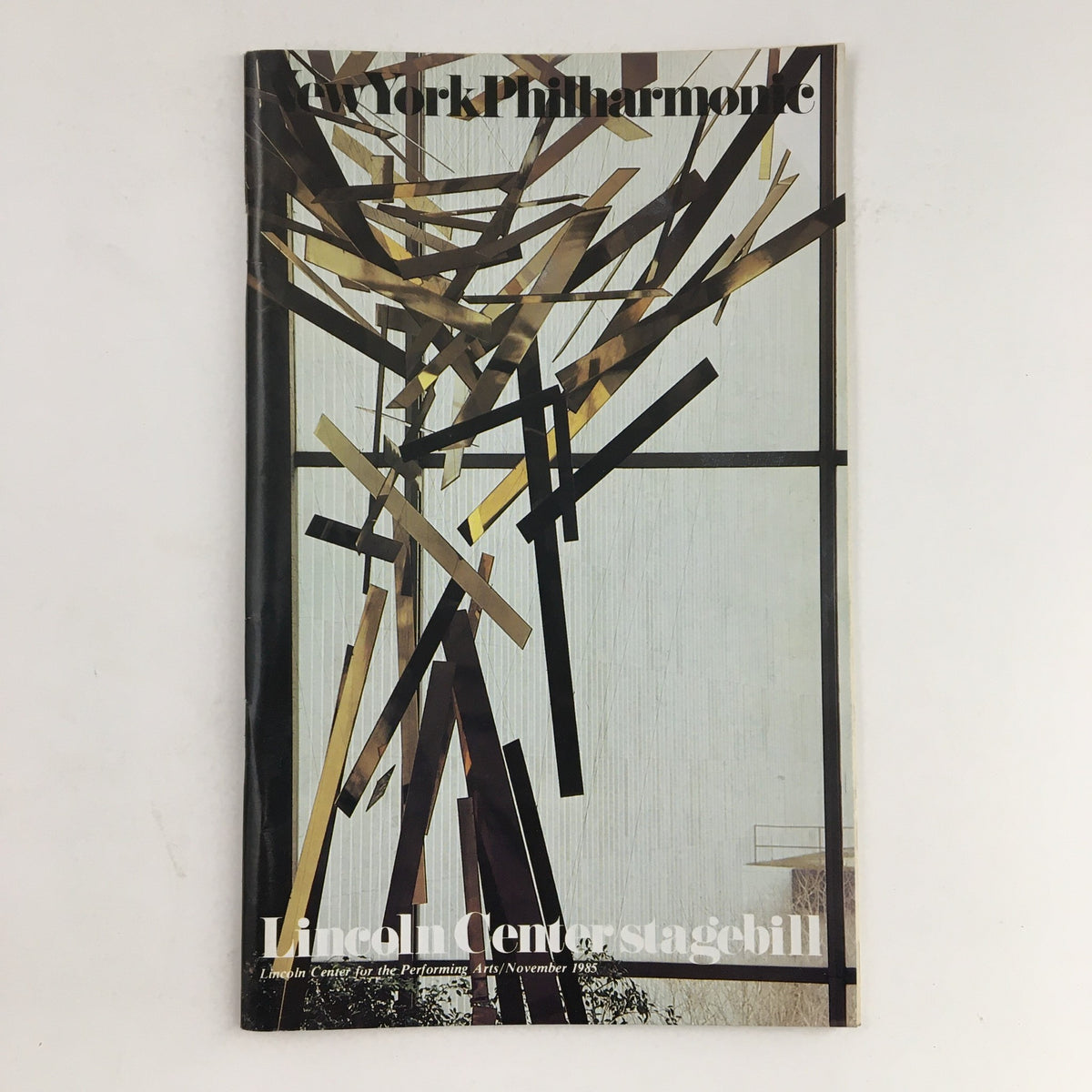 1985 Stagebill for the New York Philharmonic featuring Reflections From The Keyboard, decorative cover design with abstract elements. Displayed at Lincoln Center for the Performing Arts in November 1985.