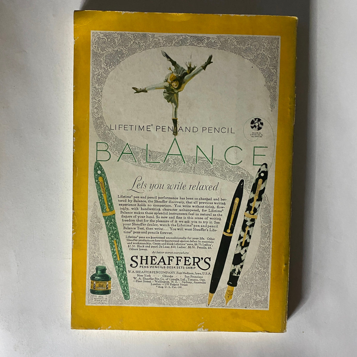 Vintage National Geographic Magazine May 1929 showcasing an advertisement for Sheaffer's Balance pen and pencil set, highlighting a ballerina motif with elegant writing instruments on a bright yellow background.