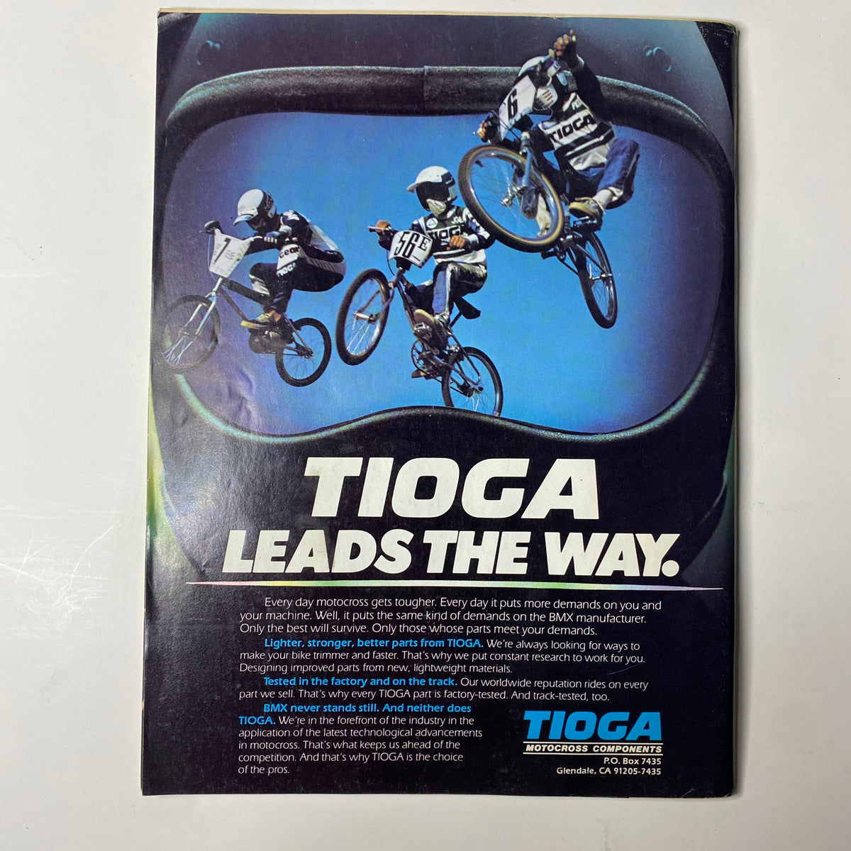 Vintage advertisement for Tioga showcasing BMX riders in action. The image is designed to promote Tioga's commitment to quality in BMX products, emphasizing the slogan 'Tioga Leads the Way.' This image is part of the BMX Action Magazine December 1983 issue featuring Toby Henderson on the cover.