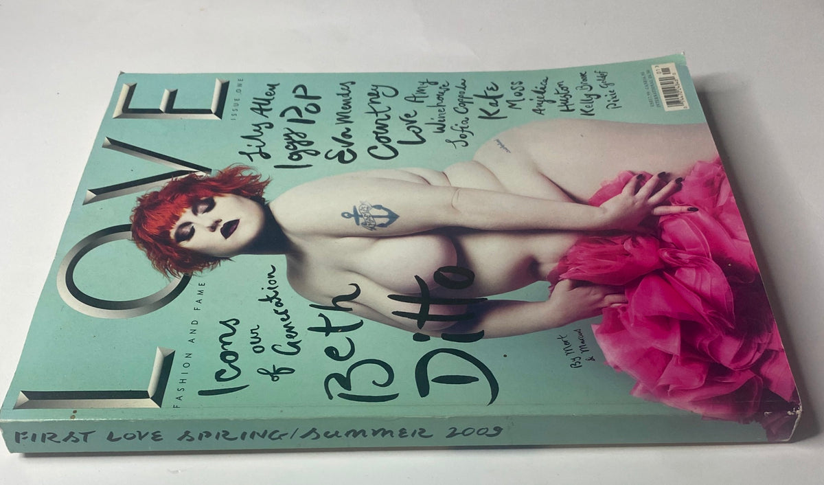 Cover of the 2009 First Love Spring and Summer Catalog featuring a model with red hair, wearing a pink outfit against a turquoise background.
