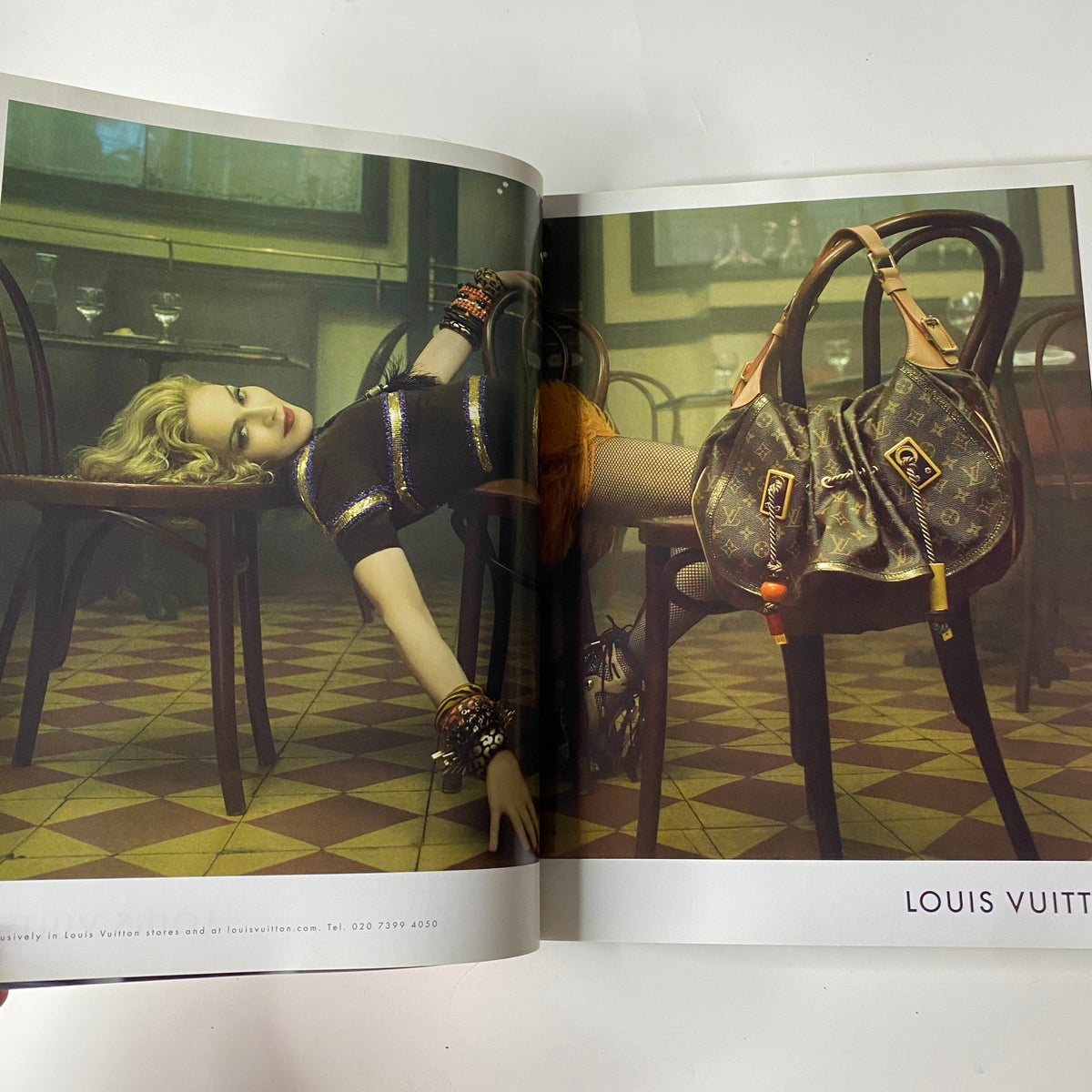 Interior page from the 2009 First Love Spring and Summer Catalog displaying a Louis Vuitton advertisement with a model lounging in a vintage setting, showcasing luxury fashion.
