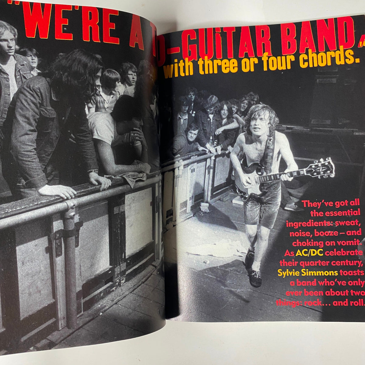 Spread in Mojo Music Magazine December 2000 displaying an interview with AC/DC, emphasizing their raw energy and iconic sound with dynamic visuals and bold typography.