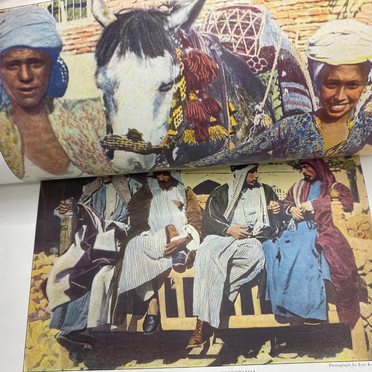 Interior page of National Geographic Magazine April 1922 displaying a colorful depiction of individuals in traditional attire with a horse, highlighting cultural aspects.