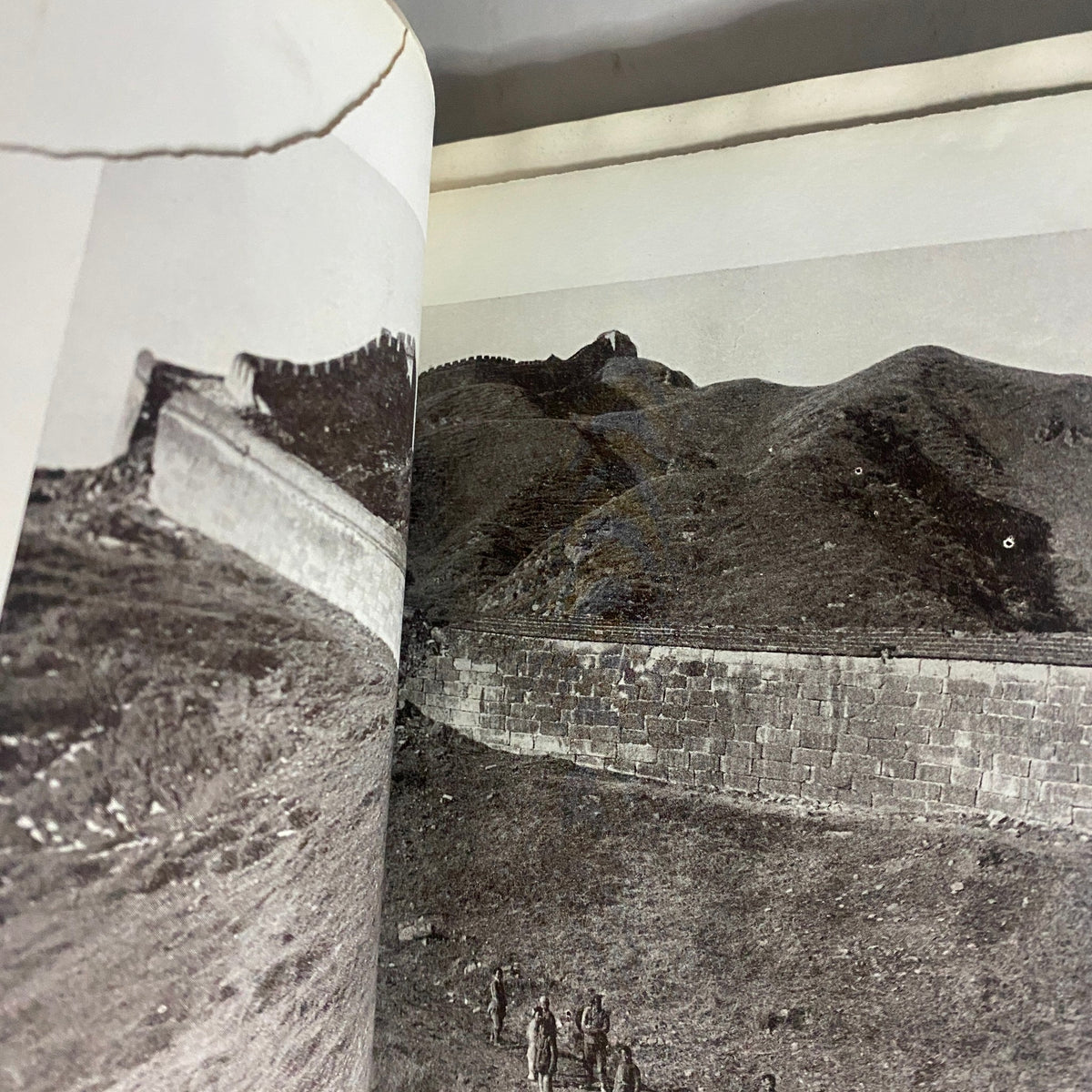 Inside page of National Geographic Magazine February 1923 displaying a black and white photograph of the Great Wall of China, highlighting its impressive structure and natural surroundings.