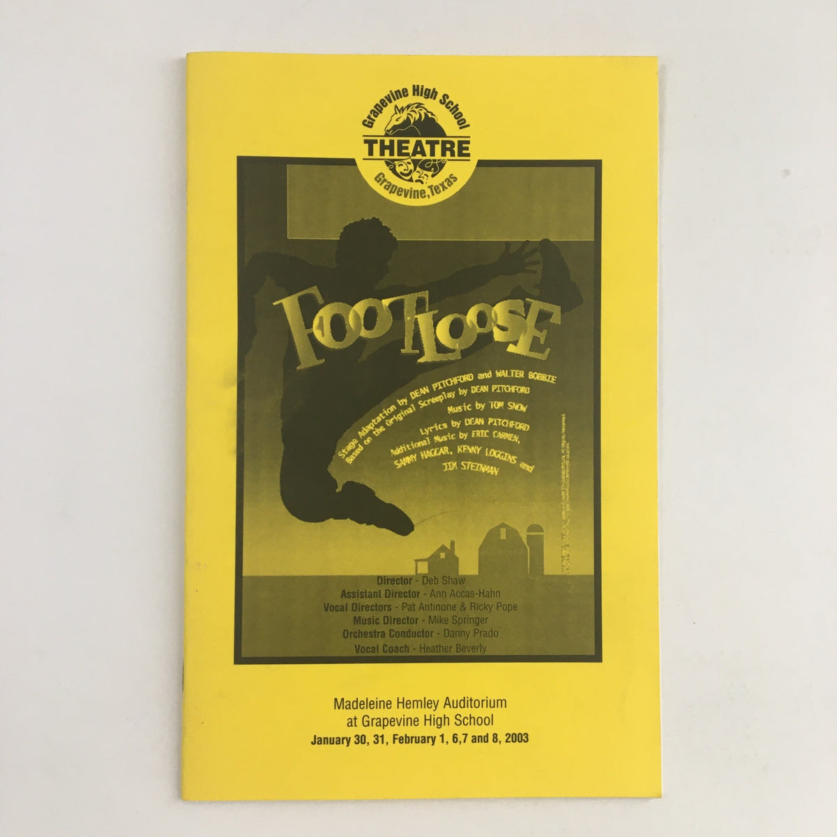 2003 Grapevine High School Theatre presents Footloose by Dean Pitchford, featuring a vibrant yellow program cover with a dancer silhouette, showcasing the production details and dates.