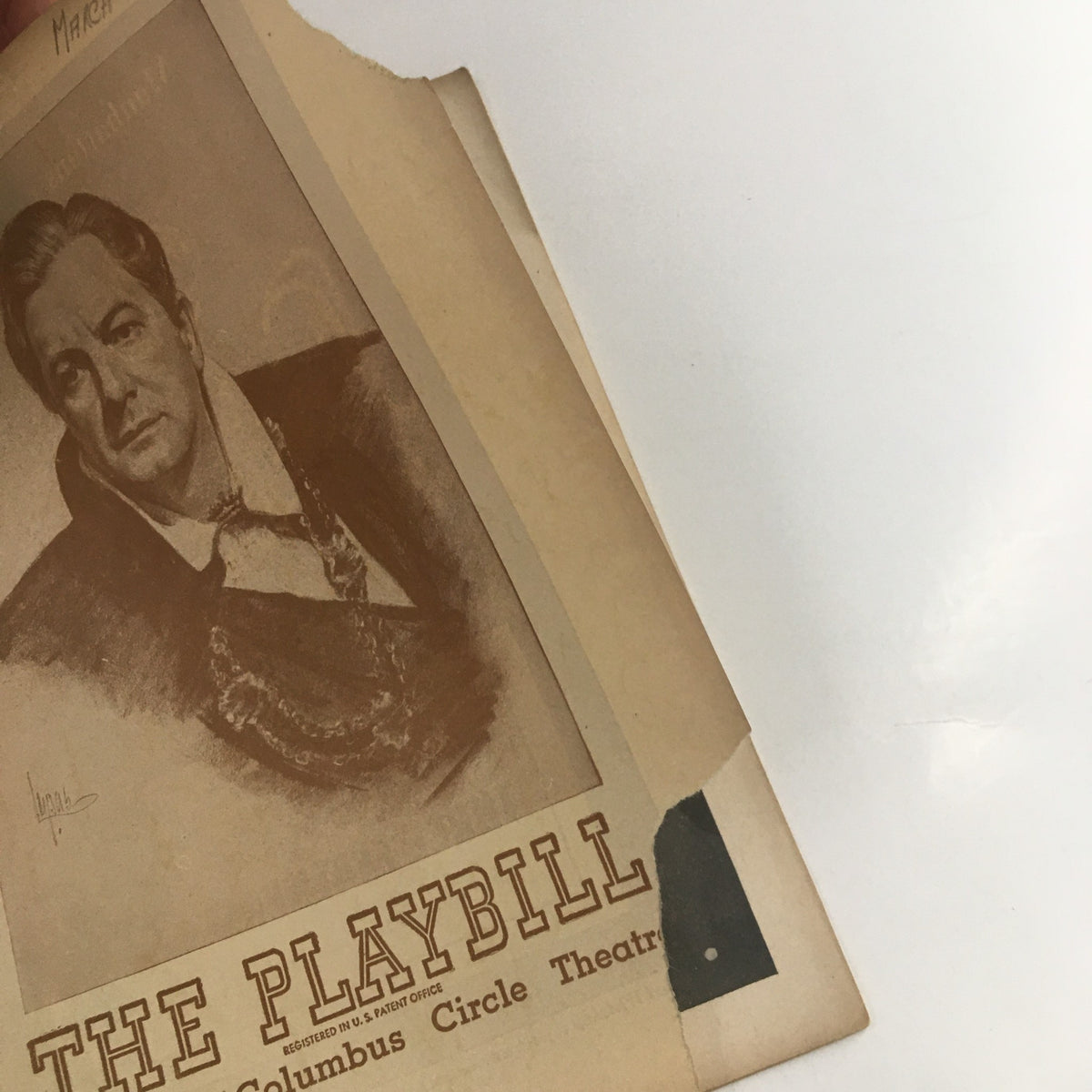 Detail view of the 1946 Playbill for Columbus Circle Theatre highlighting the opening, featuring Maurice Evans' Hamlet and decorative edge.