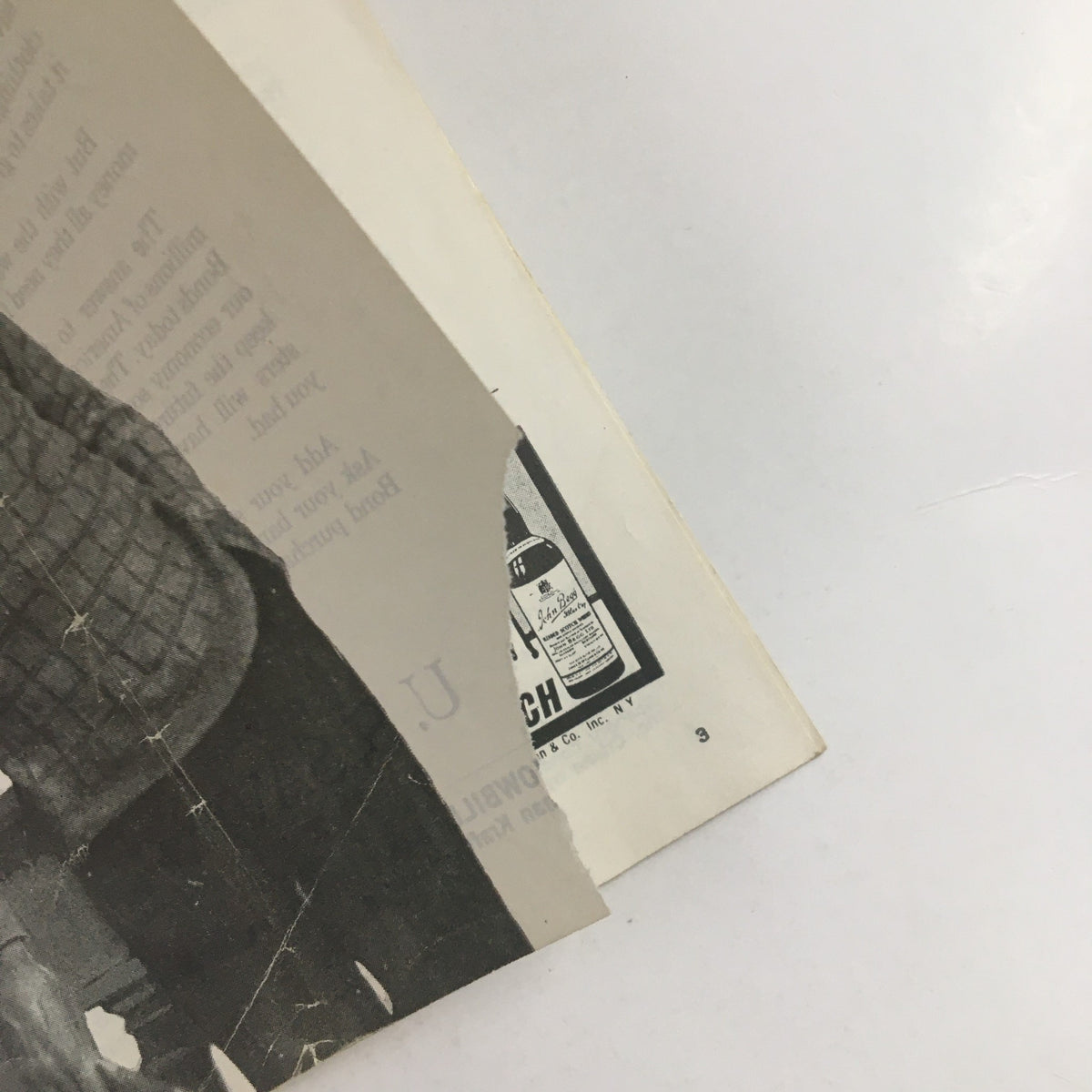 Close-up view of the edge of the 1958 Showbill for Eugene O'Neill's Desire Under The Elms, showing wear and tear with a torn corner.