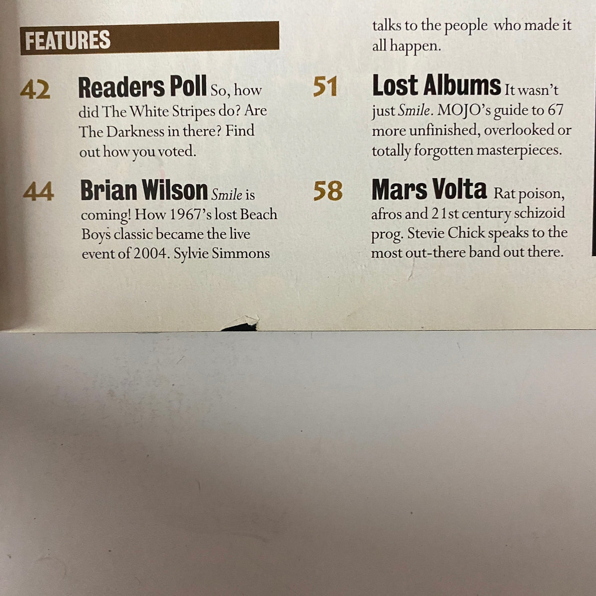Features page from Mojo Music Magazine March 2004, showcasing topics including Readers Poll, Brian Wilson's 'Smile', Lost Albums, and Mars Volta, enhancing the magazine's musical depth.
