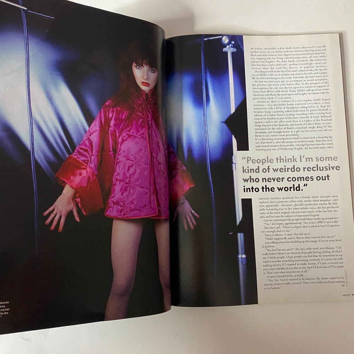 Mojo Music Magazine December 2005 showcases an image of Kate Bush in a vibrant outfit, accompanied by a quote reflecting her reclusive nature and thoughts on fame.