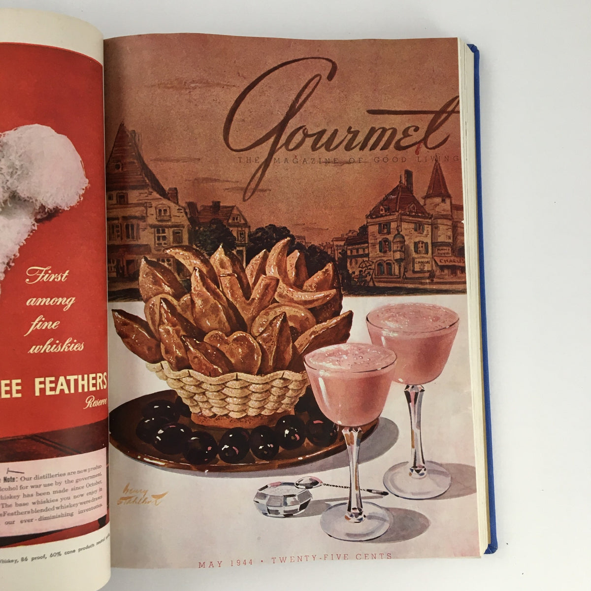 Cover illustration of Gourmet: The Magazine of Good Living, displaying a basket of snacks and drinks, featuring a classic dessert from May 1944.
