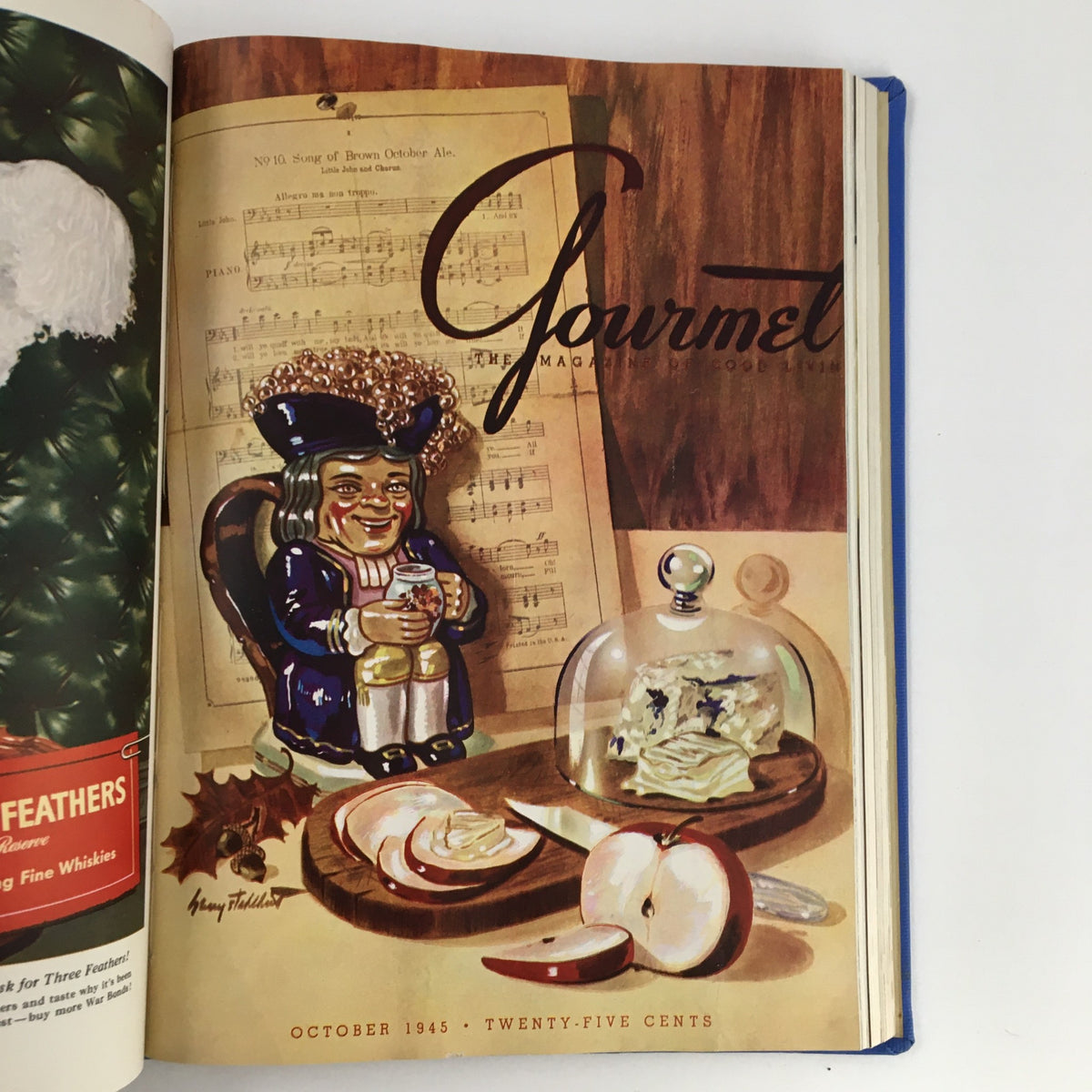 Gourmet: The Magazine of Good Living, October 1945 edition displaying a whimsical figure with a drink next to a cheese platter, embodying festive dining.