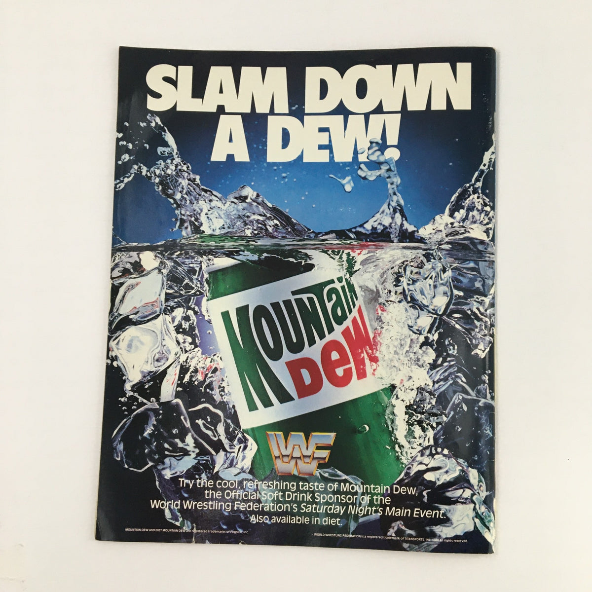 WWF Magazine July 1990 advertisement for Mountain Dew soft drink with the slogan 'SLAM DOWN A DEW!', illustrating its sponsorship of wrestling events.