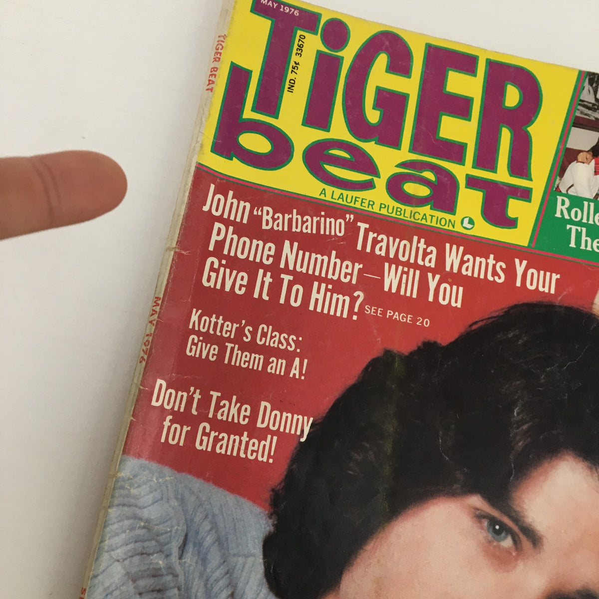 Close-up of Tiger Beat Magazine May 1976 cover highlighting John "Barbarino" Travolta and eye-catching headlines.
