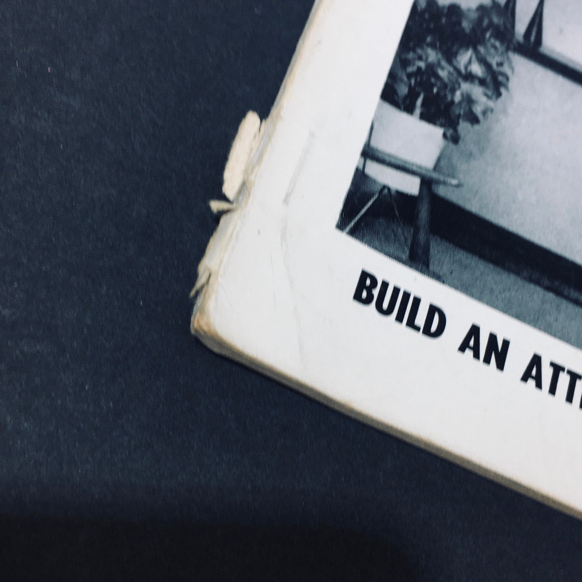 Close-up of the spine of VTG Audio Music Magazine March 1965, highlighting its wear and the phrase 'Build An Attractive Installation Like This'.