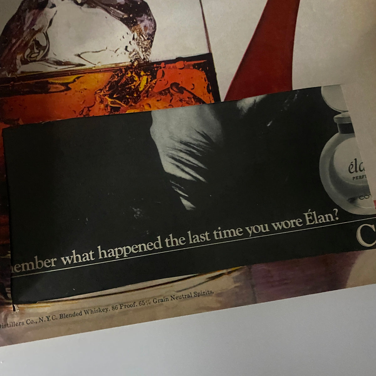 Advertisement page from an unspecified magazine featuring a shadowy figure and a perfume product, titled 'Élan,' with the phrase 'Remember what happened the last time you wore Élan?'