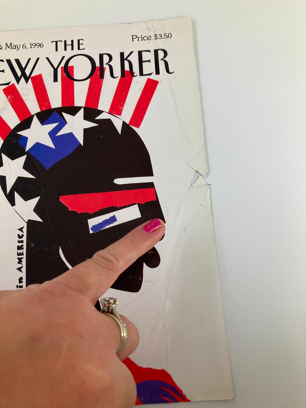 Close-up view of the April 29, 1996 The New Yorker cover, 'Black in America' by Michael Roberts, highlighting wear and a finger pointing at the design.