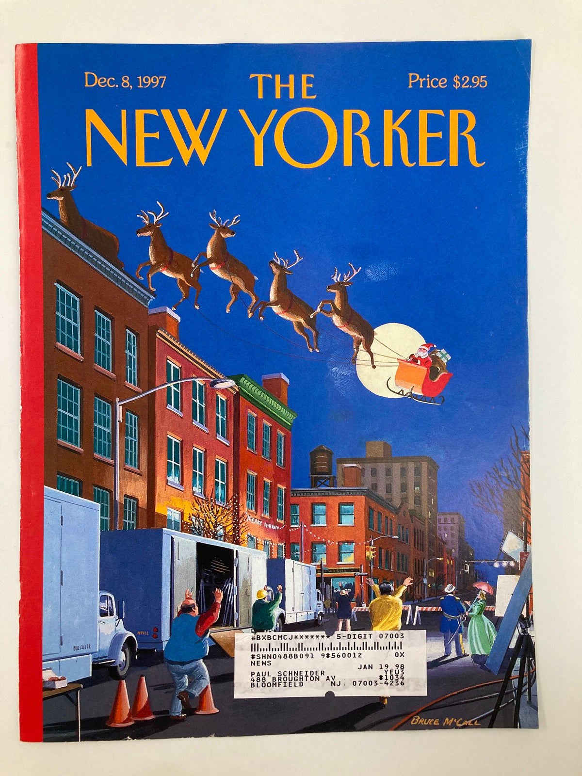 Cover of The New Yorker December 8, 1997, named 'Cut!' by Bruce McCall, displaying a festive scene with Santa and reindeer over a bustling city street.