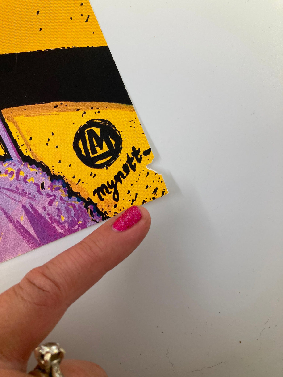 Close-up of the signature on the cover of The New Yorker, April 14, 1997, titled 'Fashion Hangup' by Lawrence Mynott, highlighting the artist's signature and artistic details.