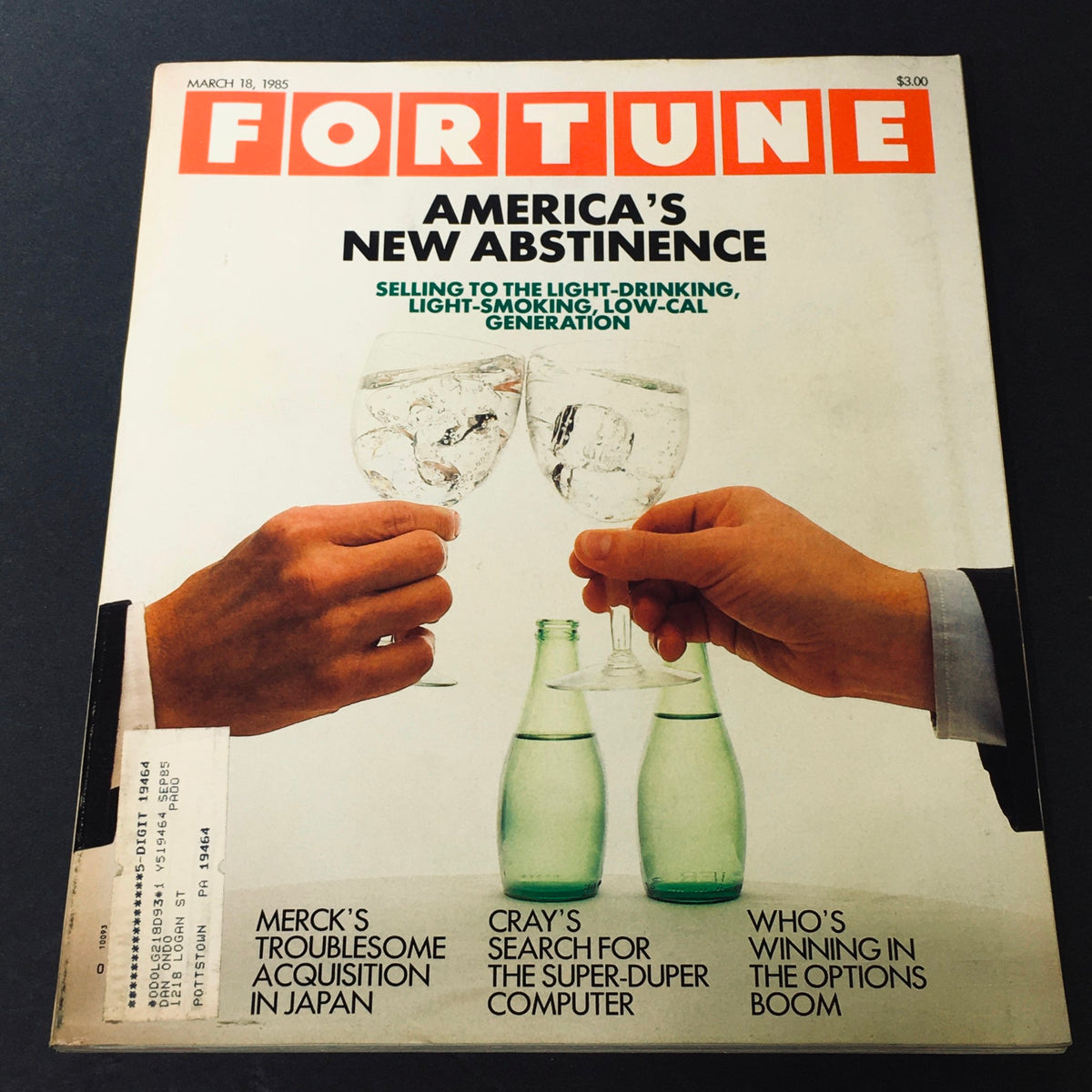 Cover of Fortune Magazine from March 18, 1985, featuring the title 'Merck's Troublesome Acquisition in Japan' and images of glasses clinking, representing themes of America's new abstinence and light-drinking trends.