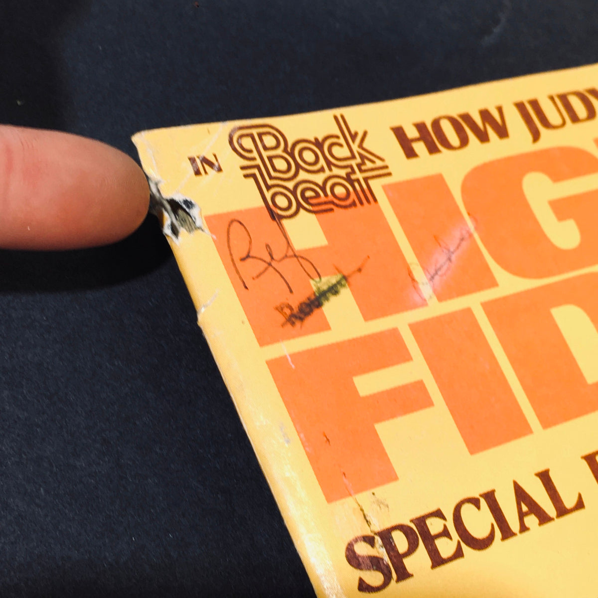 Close-up of the corner of the April 1977 High Fidelity Magazine showing minor edge damage and a handwritten note.