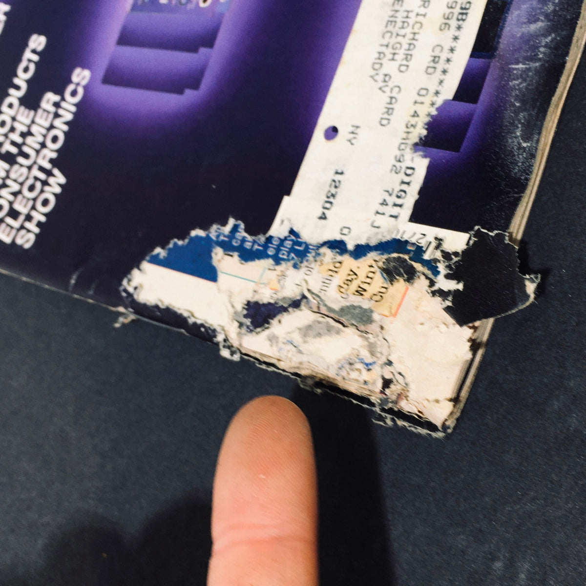 Close-up shot showing the wear and damage on the bottom corner of the Stereo Review Magazine April 1986, including fraying and torn edges.