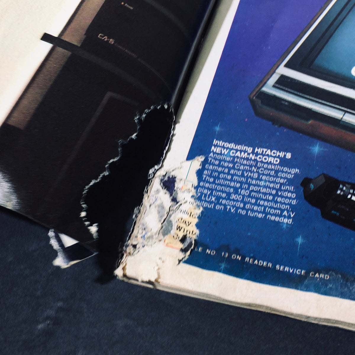 Damage on the page of Stereo Review Magazine April 1986, featuring a Hitachi videocassette recorder advertisement.