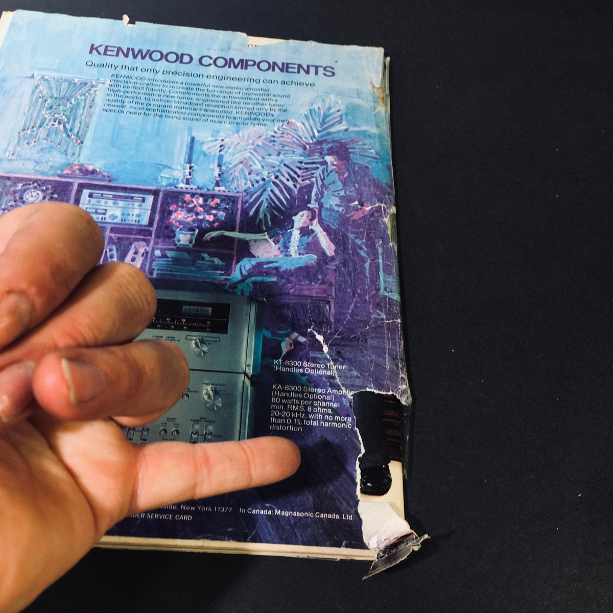 Back cover of High Fidelity Magazine July 1976, showcasing an advertisement for Kenwood audio components with visible wear and damage.