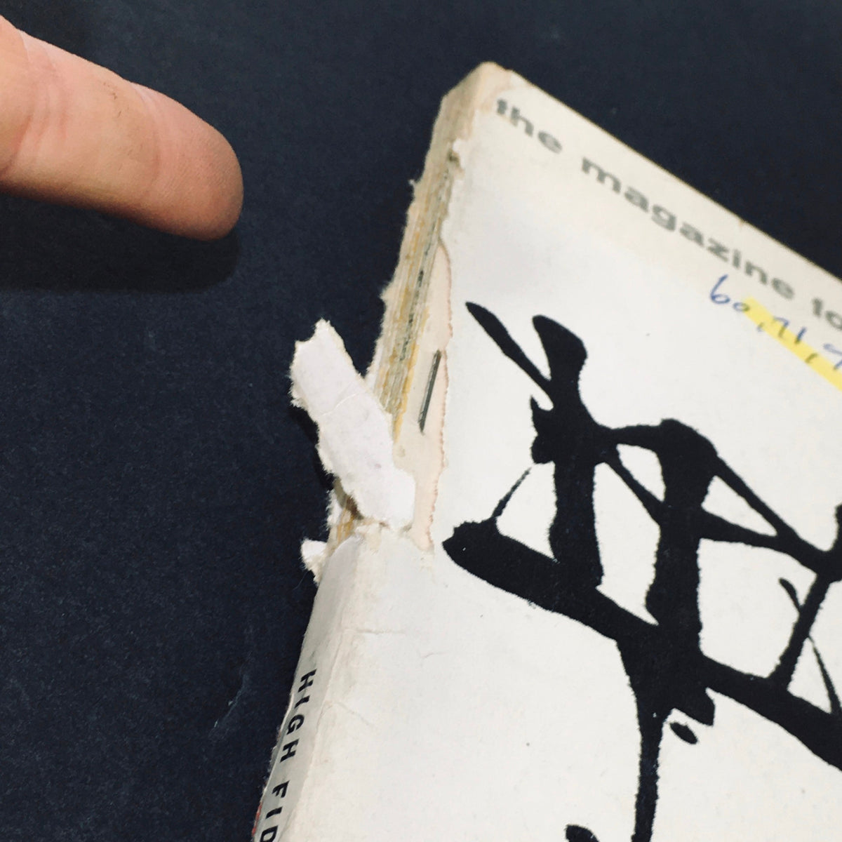 Side view of the VTG High Fidelity Magazine March 1960 displaying the magazine's wear and tear, highlighting its age and collectible nature.