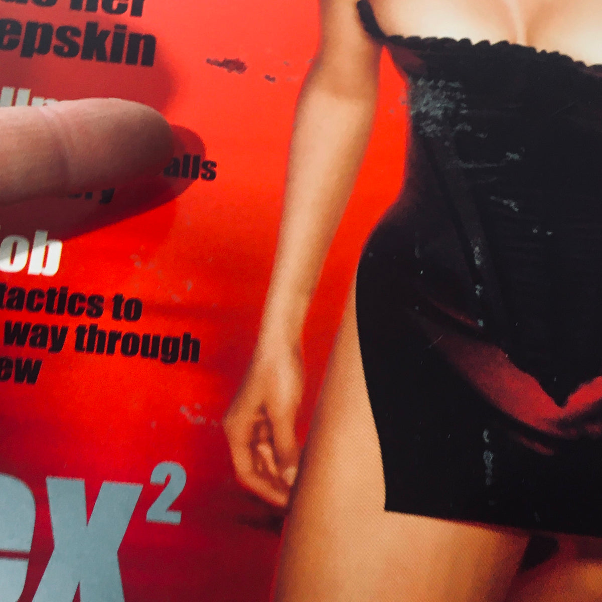 Close-up of Stuff For Men Magazine June July 2000, highlighting Lucy Lawless in a form-fitting outfit, emphasizing her bold image and features.