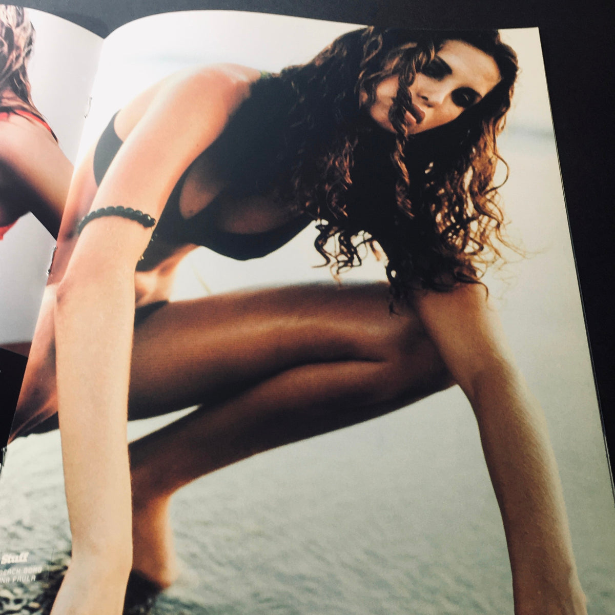 Inside page of Stuff For Him Magazine 2000 displaying an image of a woman in a bikini, posing by the water, celebrating the allure of the '100 Sexiest Women In The World'.