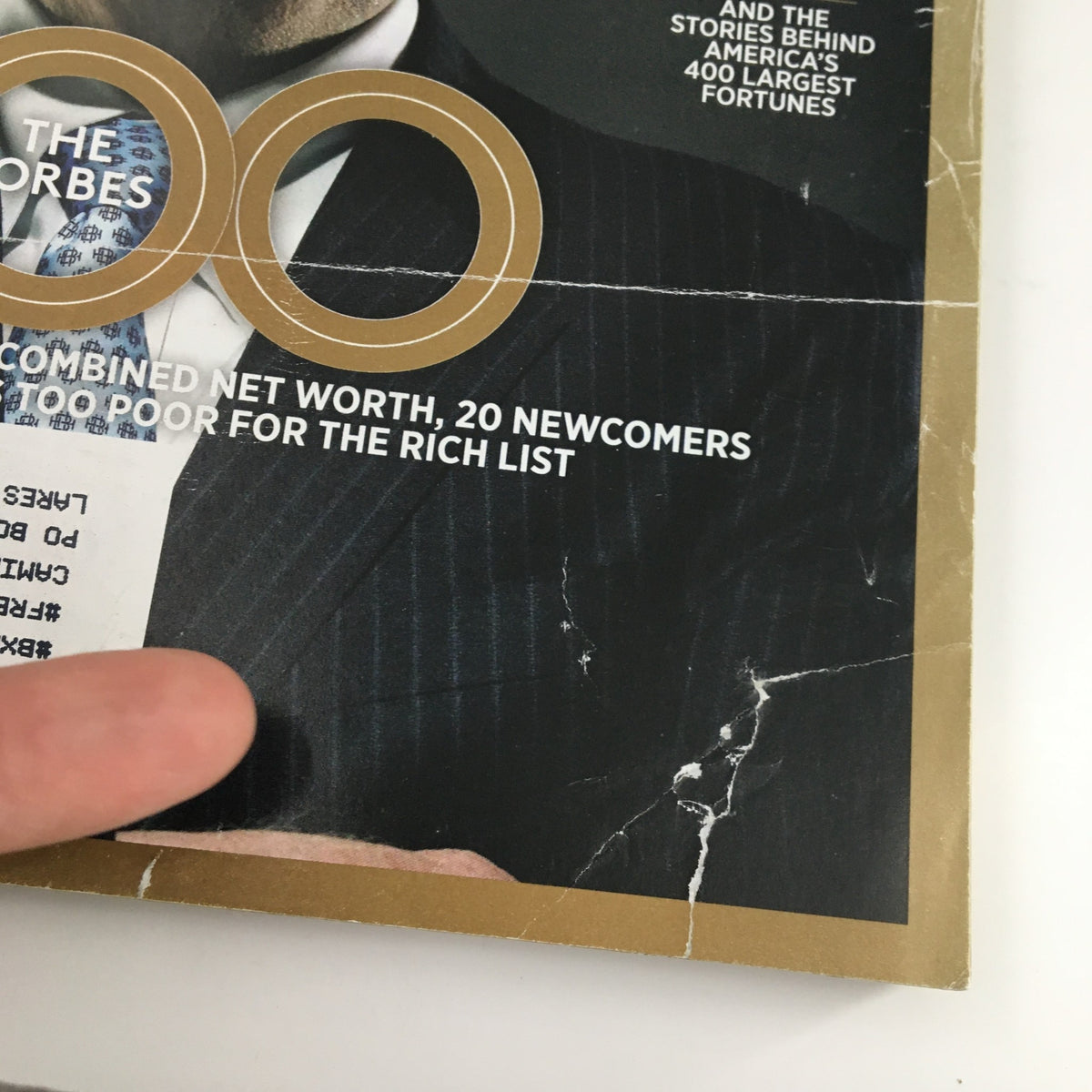 Close-up of the Forbes Magazine cover from October 7, 2013, featuring Warren Buffett, highlighting the Forbes 400 list with visible wear and damage.