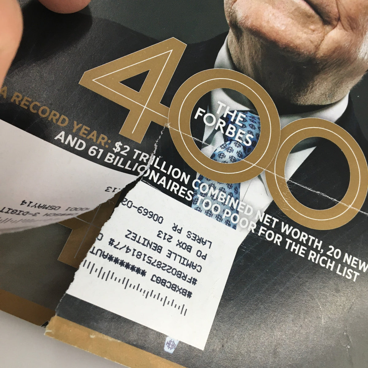 Detail view of the Forbes Magazine cover dated October 7, 2013, showcasing Warren Buffett with a torn section, emphasizing the Forbes 400 list and its significance.