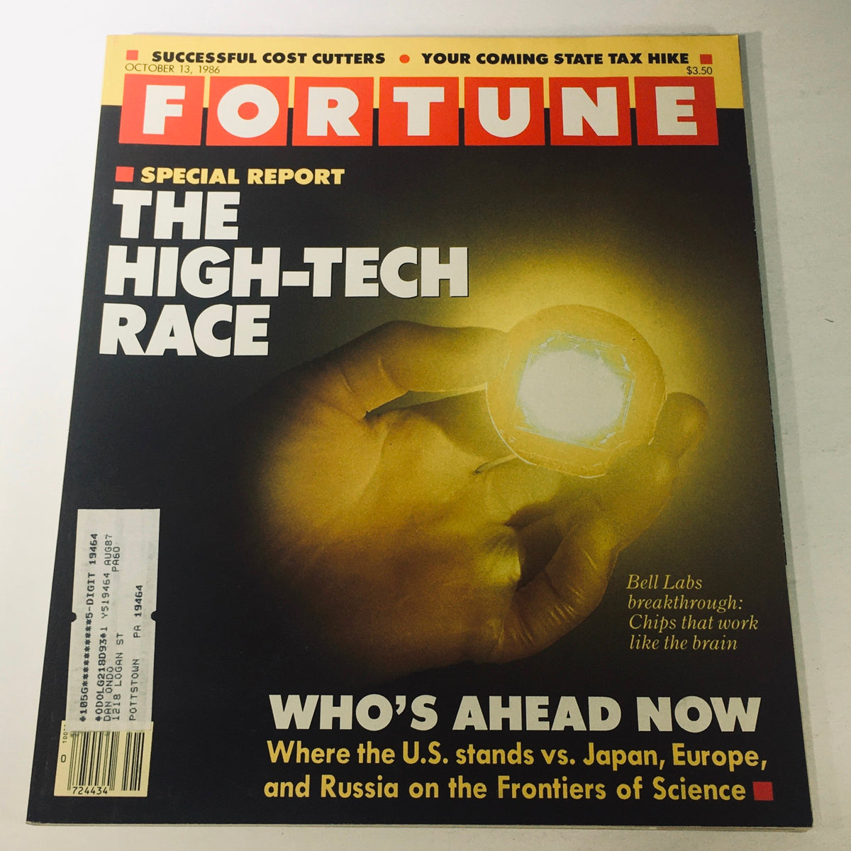 Cover of VTG Fortune Magazine October 13 1986 showcasing 'The High-Technology Race' with a focus on Bell Labs innovations and breakthrough technology. The image features a hand holding a chip designed to function like the brain, highlighting the magazine's special report on the technological advancements of the era.