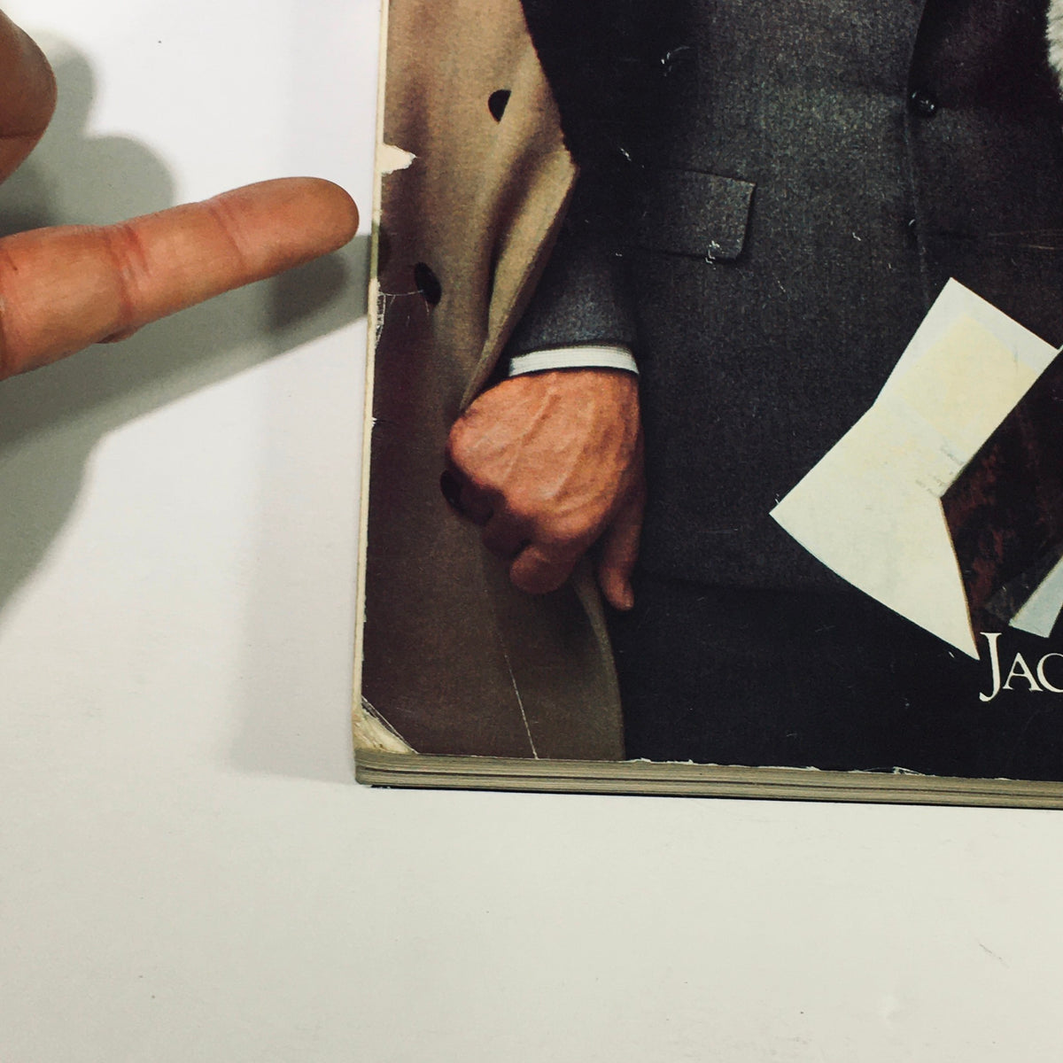 An image showcasing the hands of a gentleman in a suit holding a magazine page, with a focus on the magazine titled Philadelphia Magazine November 1980 - The New Chinese Restaurants.