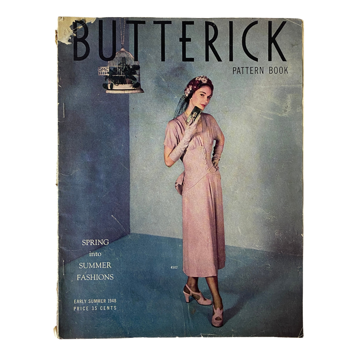 1948 Butterick Spring and Summer Pattern Book Catalog cover featuring a woman in a stylish pink dress and elegant hairstyle, showcasing mid-century American fashion.