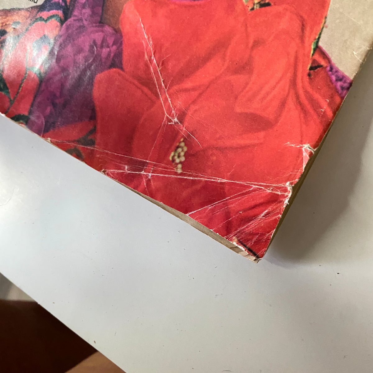 Close-up of the damaged corner of Vogue Magazine January 15, 1972 Lynn Woodruff Cover, showcasing wear imperfections on the cover.