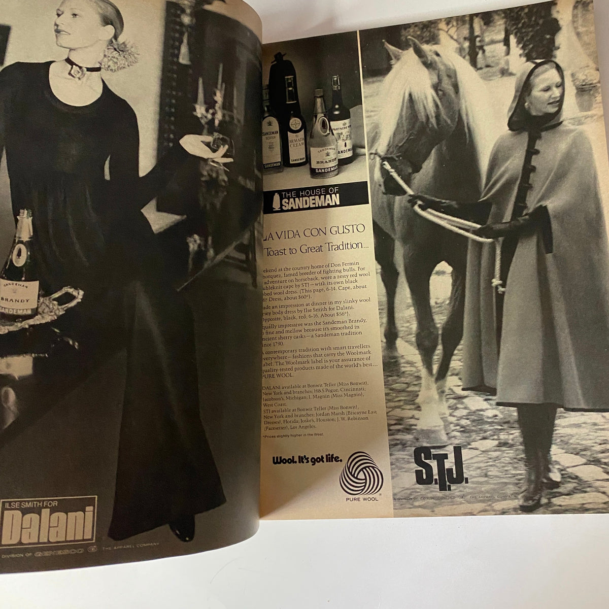 Vogue Magazine September 1, 1971 double-page spread showcasing an advertisement with a model in a black dress holding a tray, emphasizing elegance and sophistication.
