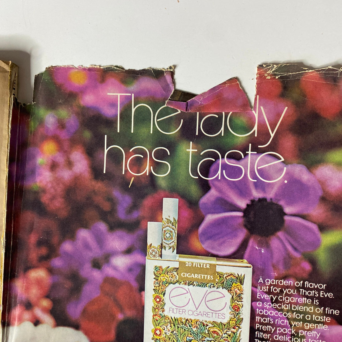 Vogue Magazine September 1, 1971 advertisement for Eve cigarettes, highlighting appealing floral background and saying 'The lady has taste'.