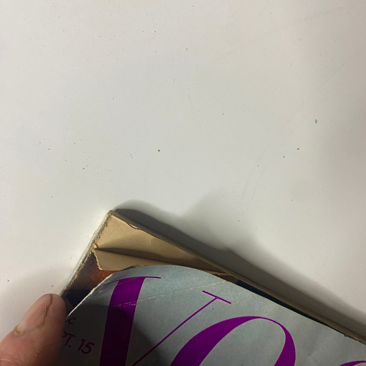 Close-up image showing the wear and tear on the corner of the Vogue Magazine September 15, 1971, indicating its vintage condition.