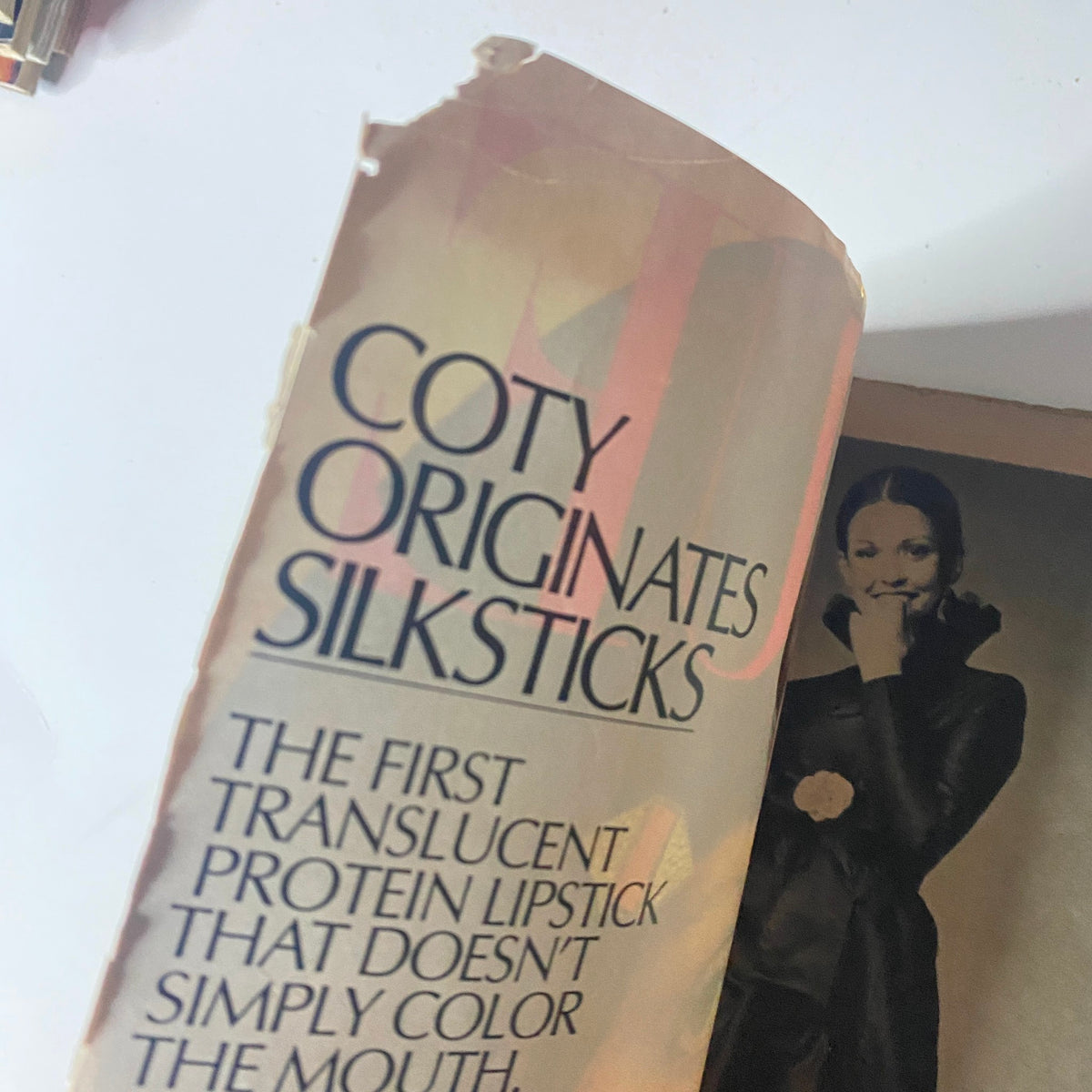 Vogue Magazine, October 1, 1971, interior page featuring an advertisement for Coty Silksticks lipstick, emphasizing beauty trends from the early 1970s.