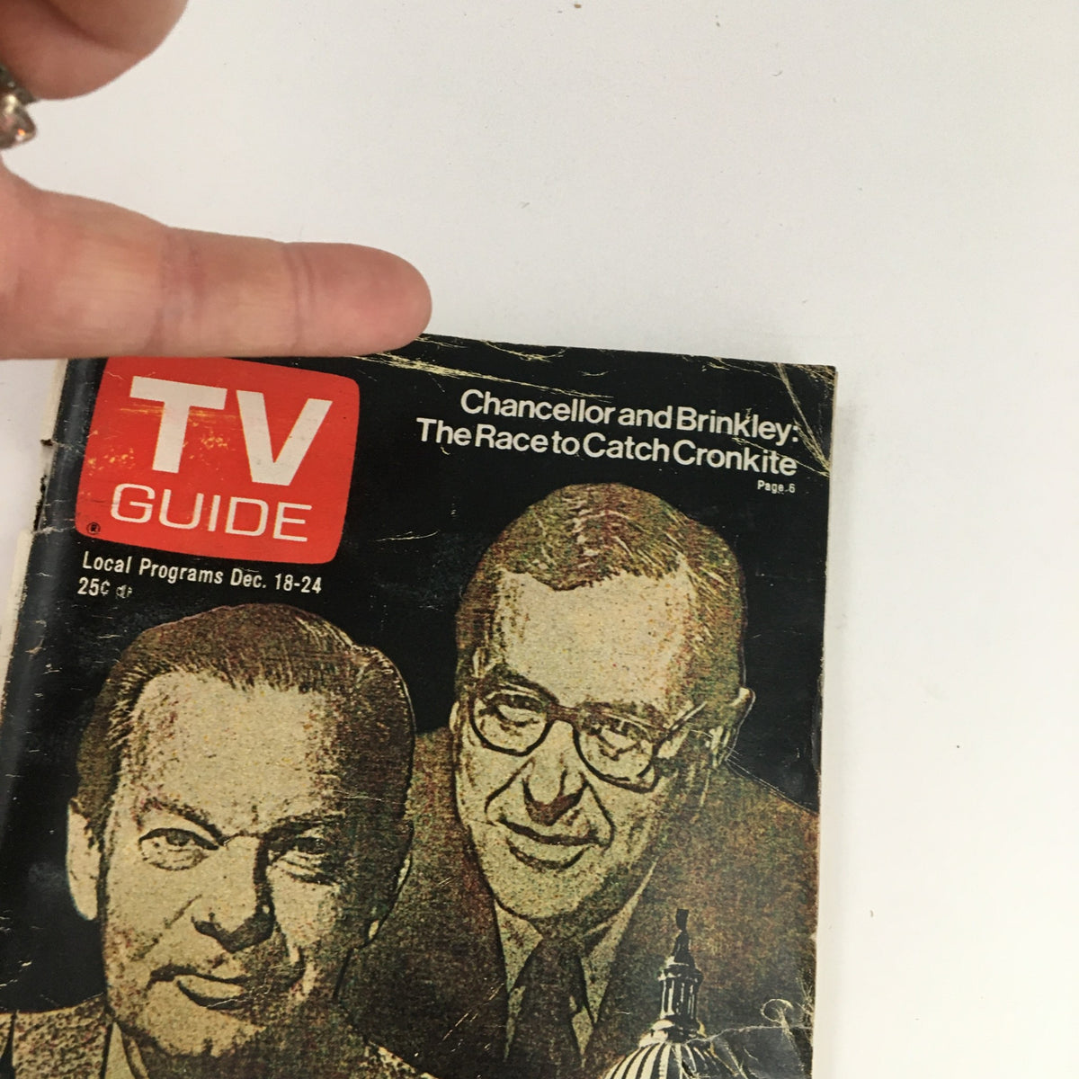 Close-up of the cover of TV Guide Magazine December 18 1976 with visible details of David Brinkley and John Chancellor, including the headline 'Chancellor and Brinkley: The Race to Catch Cronkite'.