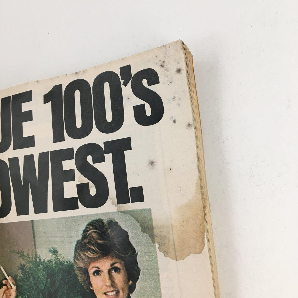 Close-up of an article from the TV Guide Magazine September 4, 1976, with bold headline about 'True 100's lowest', featuring a vintage photo of a woman, reflecting advertising styles of the 1970s.
