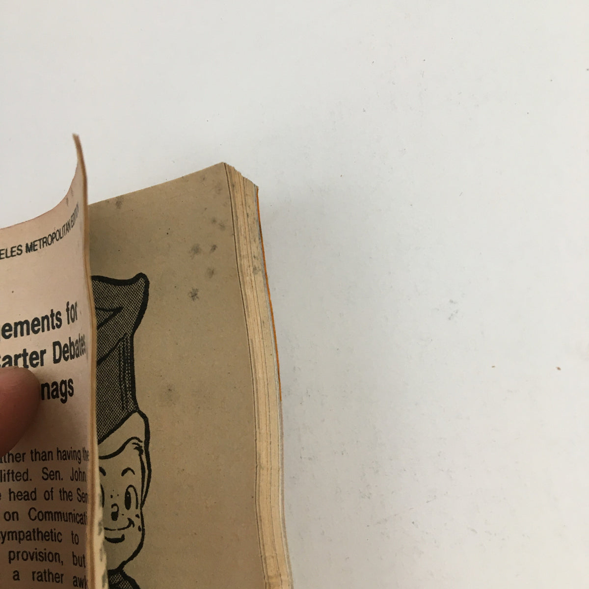 Close-up view of the spine and edge of the TV Guide Magazine from September 4, 1976, L.A. Edition, showing wear and a cartoonish character illustration, reflecting its vintage condition.