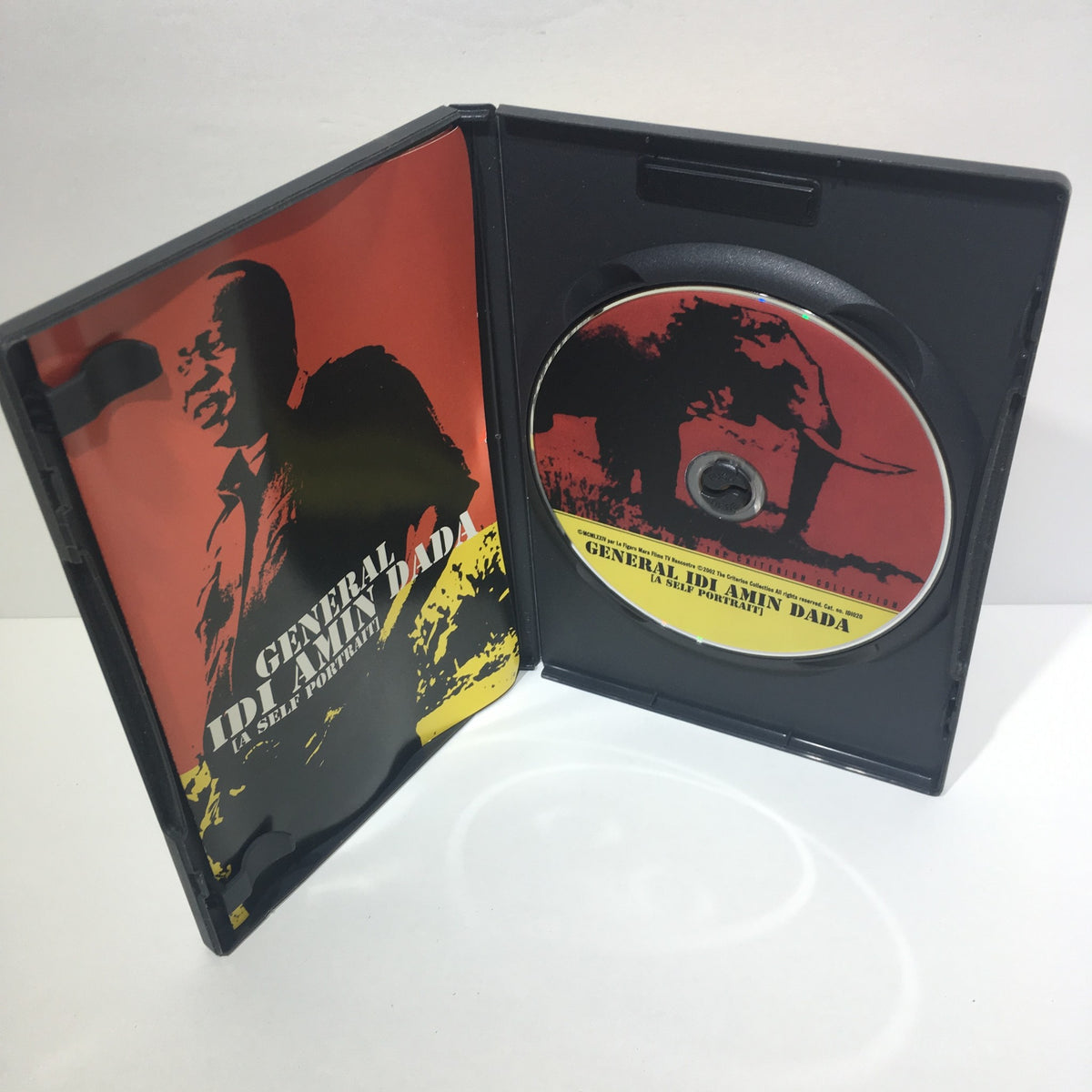 Inside view of the General Idi Amin Dada (The Criterion Collection) DVD showing the disc and inner cover art with images of Idi Amin and an elephant.
