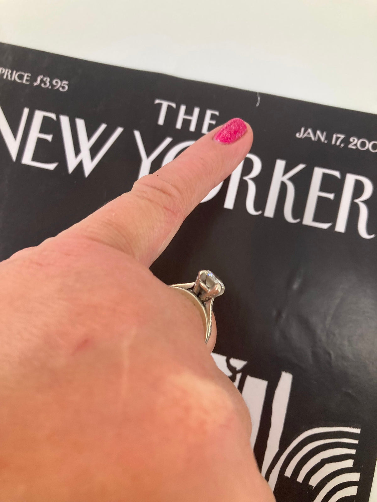 Close-up image of The New Yorker cover dated January 17, 2005, highlighting the detailed illustration by Saul Steinberg and a person's hand pointing at the cover, showcasing its significance in tsunami response.