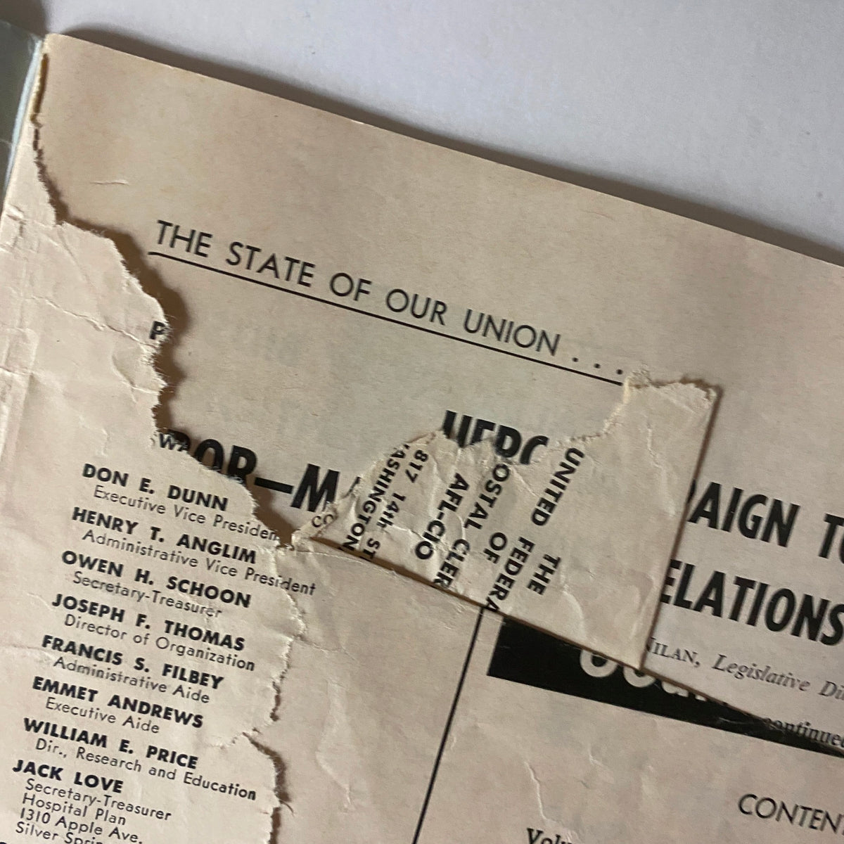 Close-up of the torn cover of The Union Postal Clerk Journal - April 1968, highlighting details about the union and postal service negotiations.