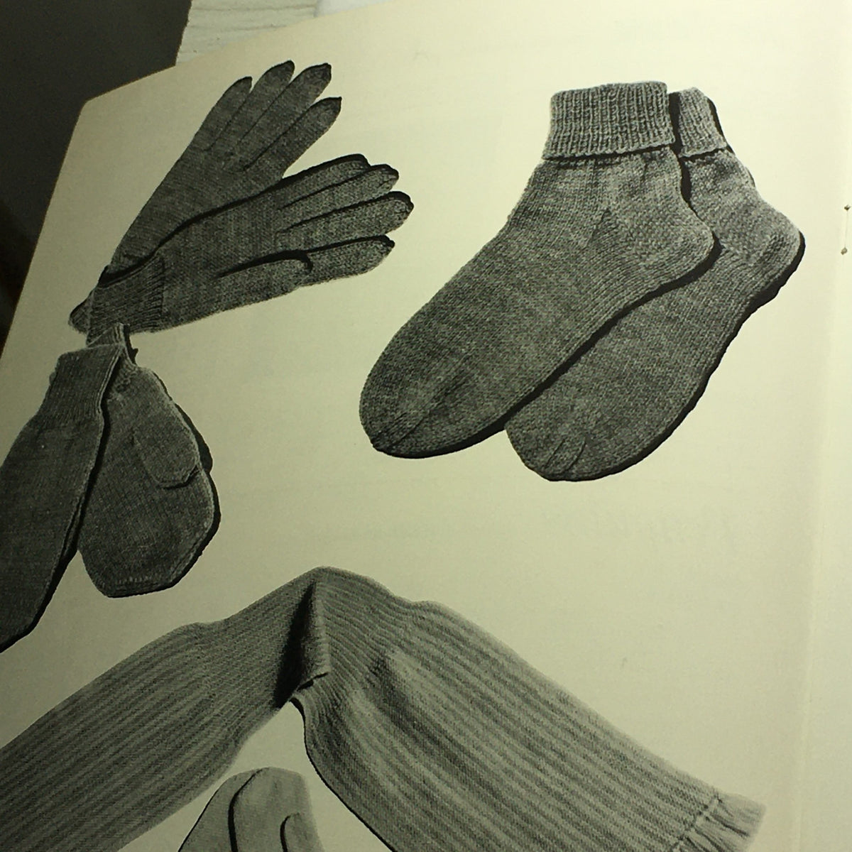 VTG 1950 Sweet Sue Knitting Catalog image of knitted gloves, socks, and leg warmers, highlighting classic knitted accessories.