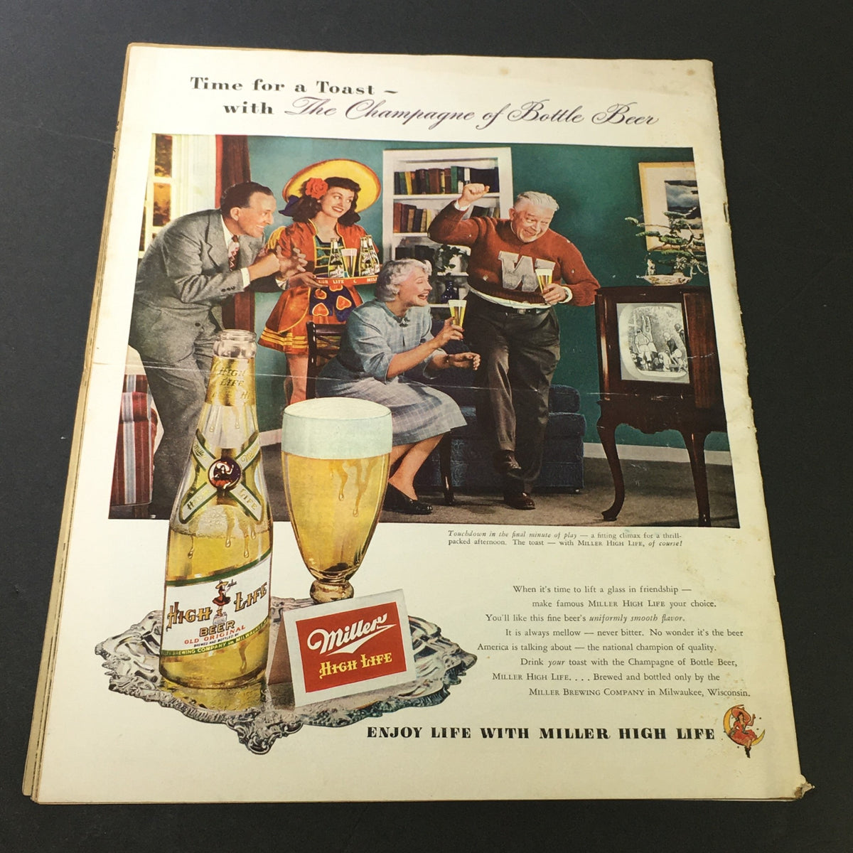 Vintage advertisement featuring a social gathering with people toasting with Miller High Life beer, showcasing the phrase 'Time for a Toast - with The Champagne of Bottle Beer,' reflecting the 1949 design aesthetic.